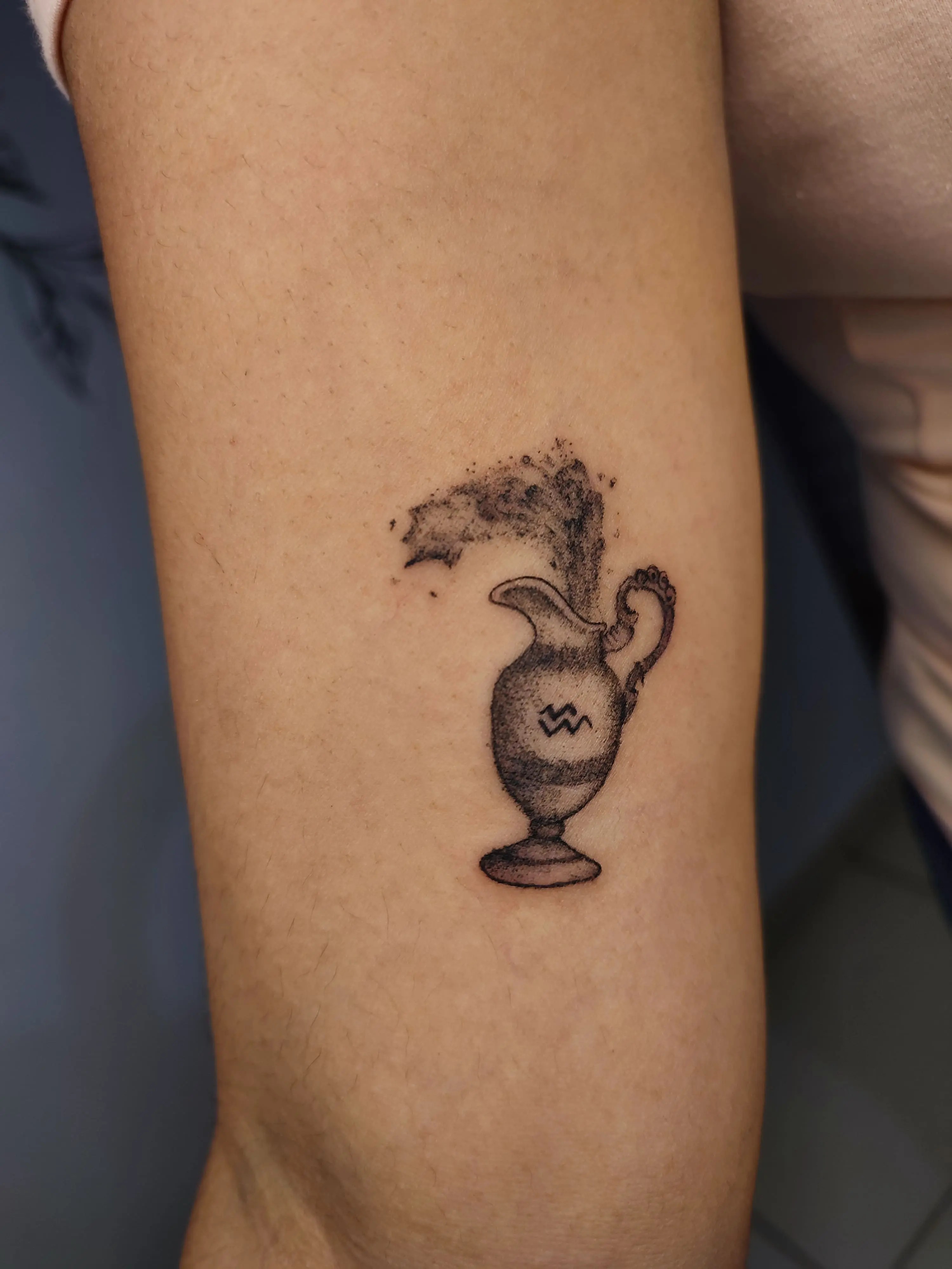 Tatuagem uma jarra jorrando agua